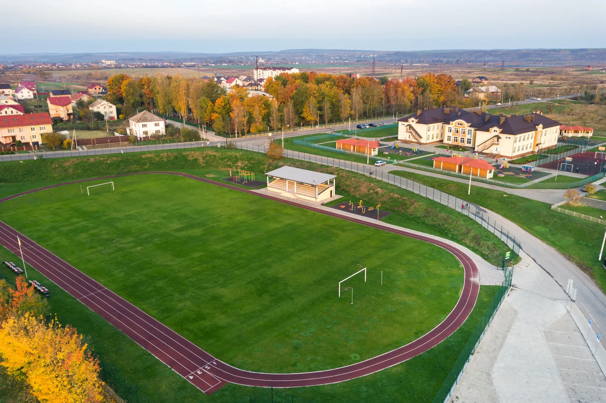 aerial-view-of-sports-stadium-with-red-running-tra-2024-12-06-13-45-34-utc